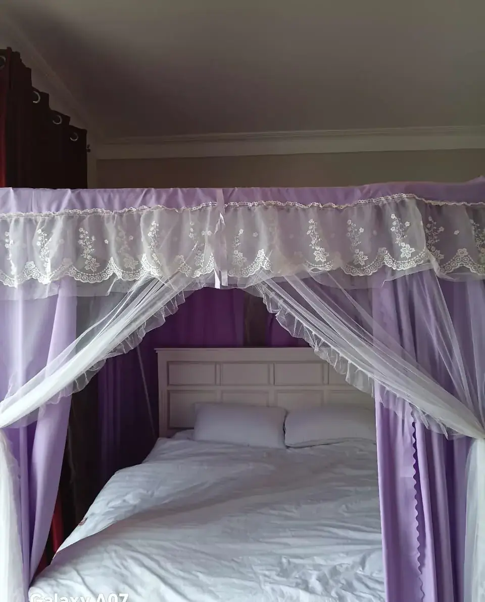 Royal Canopy Suite lilac canopy bed with lace drapes